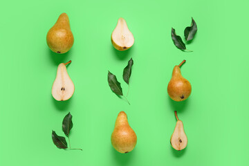 Ripe pears with leaves on green background