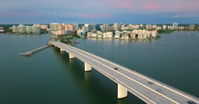 John Ringling Causeway leading from downtown to St. Armands Key in Sarasota city, Florida. Waterfront office highrise buildings and car traffic on bridge