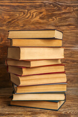 Stack of old hardcover books on wooden background