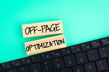 laptop keyboard and wooden with the word OFF-PAGE OPTIMIZATION