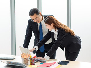 Asian professional successful male businessman mentor supervisor in formal suit standing smiling...
