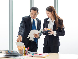 Asian professional successful male businessman mentor supervisor in formal suit standing smiling...