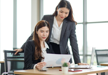 Asian professional successful female businesswoman supervisor mentor in formal suit standing...