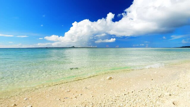 Beautiful view of tropical sea or ocean waving by the white beach and floating a clouds in the blue sky in summer, Okinawa in Japan, Nobody, Landscape or travel