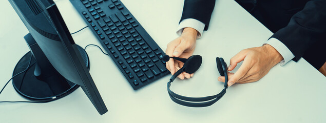 Business people wearing headset working in office to support remote customer or colleague. Call...