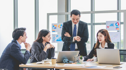 Asian professional successful businessman manager entrepreneur in formal suit standing teaching...