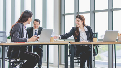 Asian professional successful female businesswoman supervisor mentor in formal suit sitting smiling...