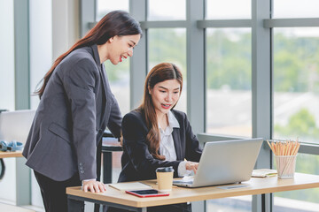 Asian professional successful female businesswoman supervisor mentor in formal suit standing...