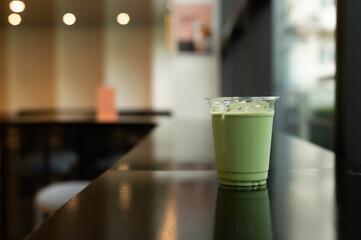 Iced matcha green tea latte in cafe