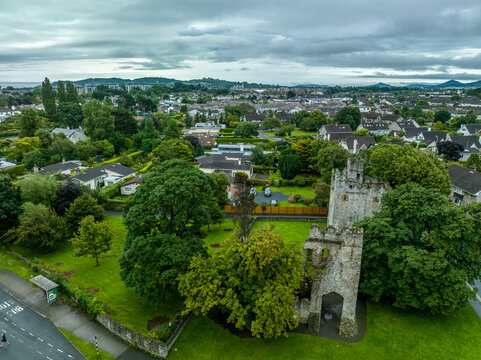 Aerial view of Monkstown castle near Dublin Ireland with restored gate tower and keep dramatic sunset sky