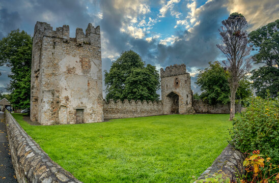 Aerial view of Monkstown castle near Dublin Ireland with restored gate tower and keep dramatic sunset sky