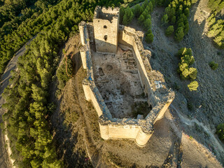 Aerial view of Davalillo castle above the Ebro river in Rioja Spain, with semicircular towers and tower of homage medieval defensive residential building, blue cloudy sky background © tamas