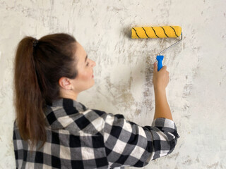 Woman with yellow Paint Roller. wall primer