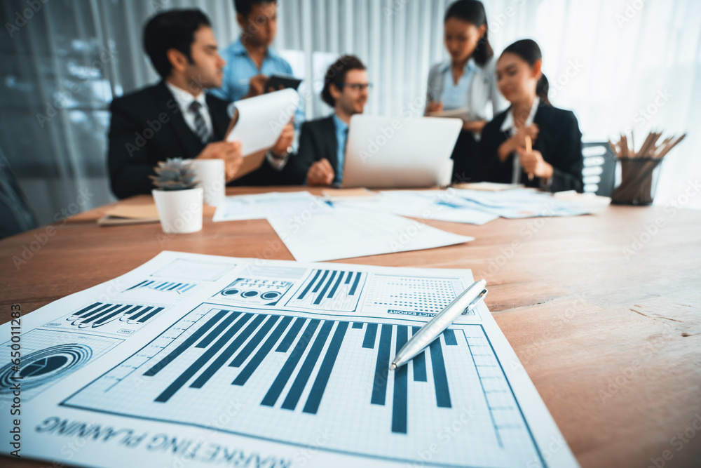 Aufkleber piles of analyzed financial data dashboard on meeting table with background of business people analy
