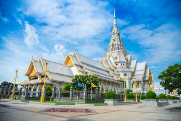 Wat Sothon Wararam Worawihan in Chachoengsao, Thailand. Beautiful white and golden temple at rural Thailand with blue sky and cloud.