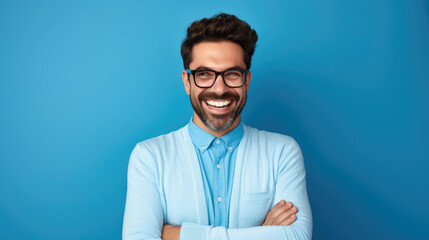 Smile of a young enterpreneur blue attire, standing against blue background