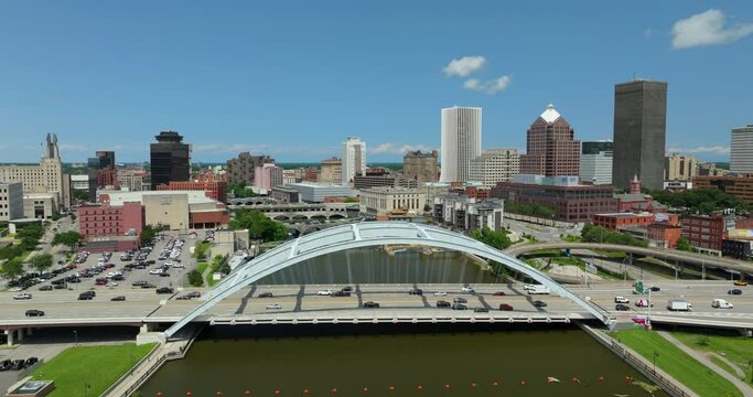 Rochester city downtown with cars driving on Frederick Douglass Susan B. Anthony Memorial Bridge over Genesee River in upstate New York. Urban architecture in the USA
