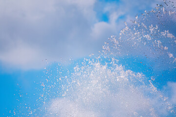 Splashes of water against the blue sky background