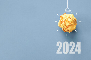2024 Yellow paper light bulb, innovative business vision and  new year resolution goal, energy...