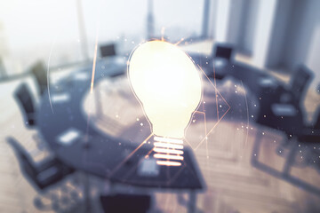 Abstract virtual light bulb hologram on a modern boardroom background, idea concept. Multiexposure