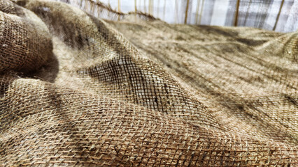 Natural fabric texture, frame and background of burlap. Rough crumpled burlap background. Selective and partial focus