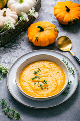Pumpkin soup with pumpkin seeds served in bowl