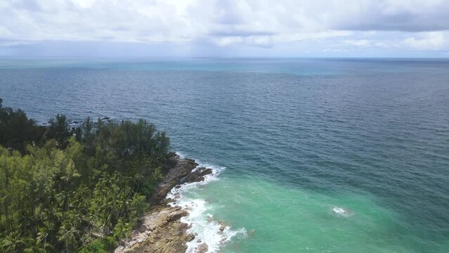 Top view from drone of beautiful coral reef beach. Clear blue aquamarine water and clouds reflection on the sea surface