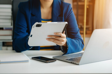 Business woman hand using laptop, tablet and smartphone in office. Digital marketing media mobile app and discussing plan new start up project.