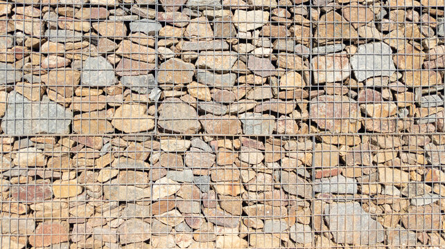 gabion steel metal stone basket background facade restored wall assembled with stones of different sizes