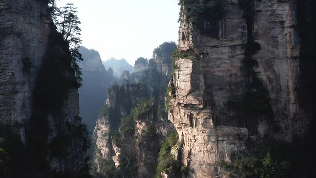 Drone push in past mystical cliff valleys between mountain spires zhangjiajie, Wulingyuan Hunan China