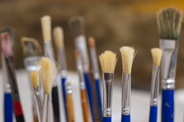 Selective focus on paint brush in art studio.