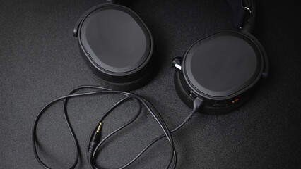 The black wired gaming headphone was captured in a close-up shot from a high-angle view.