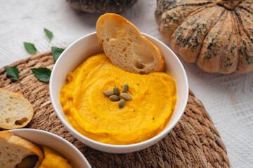 Pumpkin soup on a wooden cutting board