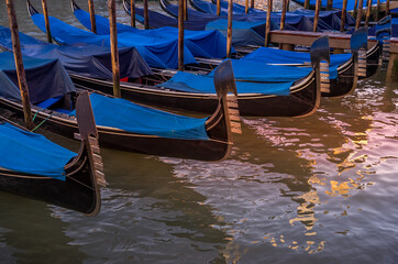 Gondolas moored at the side of the Grand Canal in Venice, Italy