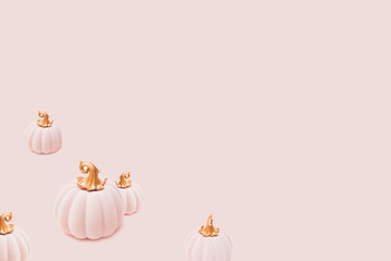 Arranged pink plush pumpkins with bronze handle on a pink background. Minimal design.