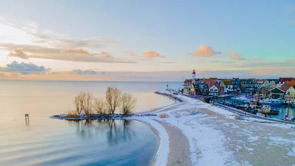 Papier Peint photo Europe méditerranéenne snow in the winter with freezing temperatures weather at the Lighthouse of Urk Netherlands during winter with snow in the Netherlands.
