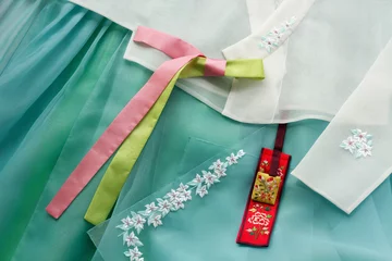 Fotobehang The colorful Hanbok, Korean traditional silk dress and ornaments for women. Holiday greeting concept with copy space. Top view.  © NoonBusin