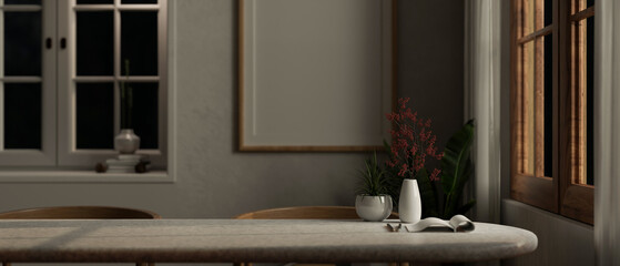 A copy space for displaying your product on a dining table in a minimalist dining room at night.