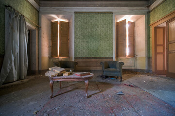 living room with sofas and coffee table in an abandoned house