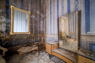 reflection of an armchair in the mirror in an abandoned house
