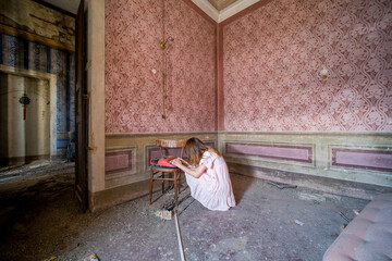 girl with a typewriter in an abandoned house