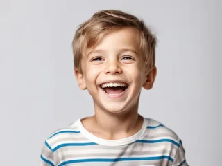 Poster Portrait of young excited laughing smiling boy child kid on studio background © magr80