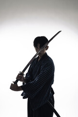 日本刀を振るう剣士のシルエット