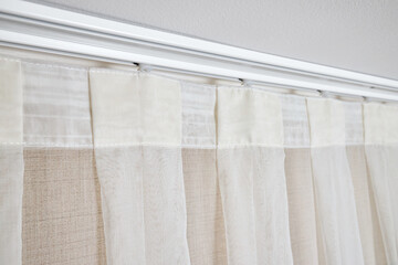 Ceiling cornice with drapes and white curtain or tulle. Interior details close up. White ceiling,...