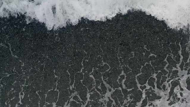 Ocean Waves Dramatically Form Crashing Waves and Textured Patterns from a Top Down View from a Drone in the Philippines.