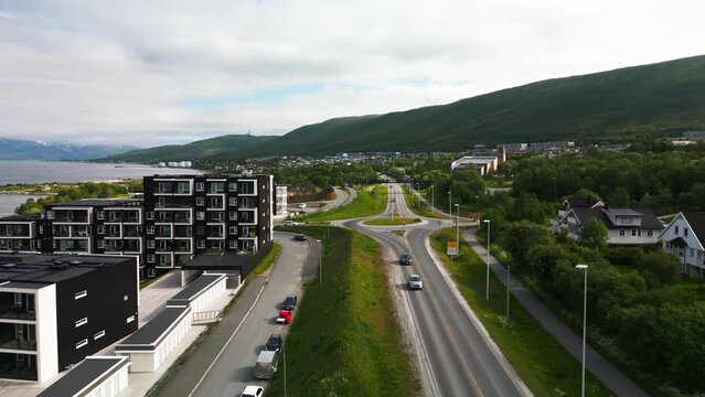 Drone flight along E8 road next to fjord in Tromso, Norway