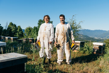 Happy beekeepers portrait in apiary
