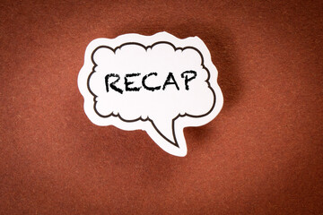 RECAP Concept. Speech bubble with text on brown background