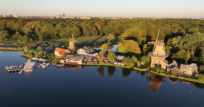 Aerial drone view of De Ster and De Lelie at Kralingse Plas in Rotterdam-Kralingen, showcasing the only remaining working snuff and spice mills in the Netherlands.