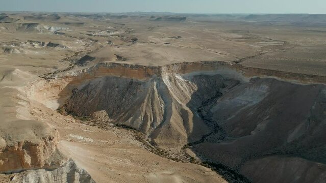 Negev Desert, Israel. Video shooting by drone 4K. Shooting at sunset, near David and Paula Ben Gurion gravesite. Panoramic desert landscape over mountains, sandy hills and rock formations.